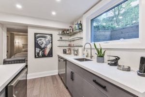 Wet Bar with and island featuring quartz countertops