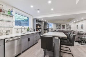 Wet Bar with island featuring quartz countertops in basement renovation